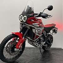 Ein rotes Ducati Adventure Motorrad mit robustem Design und LED-Scheinwerfern.