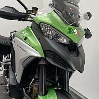 Close-up of a green Ducati Multistrada V4 motorcycle.
