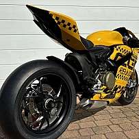 Ein gelbes Sportmotorrad mit auffälligem Design und breitem Hinterrad.
