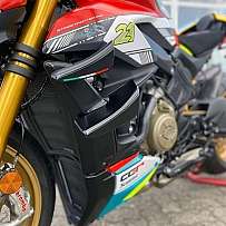 Detail view of a Ducati Streetfighter V4S motorcycle with racing elements.
