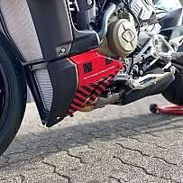 Detailaufnahme eines Motorradmotors mit rotem Schutzblech.