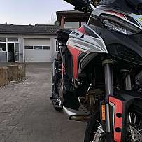 Close-up of a Ducati Multistrada V4 motorcycle parked on a driveway.