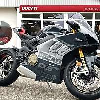 A sleek Ducati sport motorcycle parked outside a dealership.