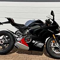 A sleek black Ducati Panigale V4 motorcycle parked.